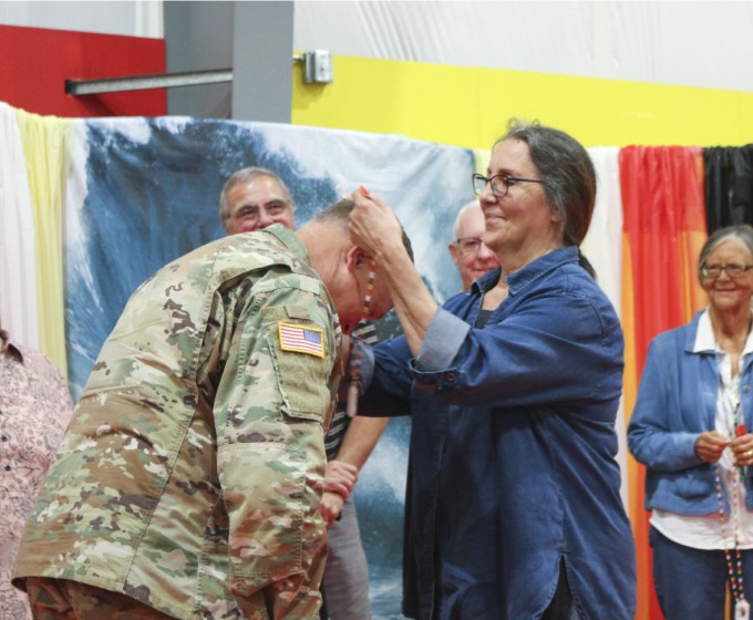 Elder Council Secretary and tribal member Lynn Clark gifts a necklace to a FEMA employee during the annual Yellow Brick Road event 1