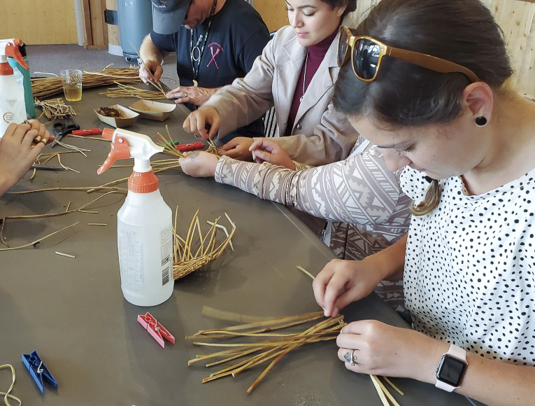 Tribal members and family learning to weave during a General Council family event 1